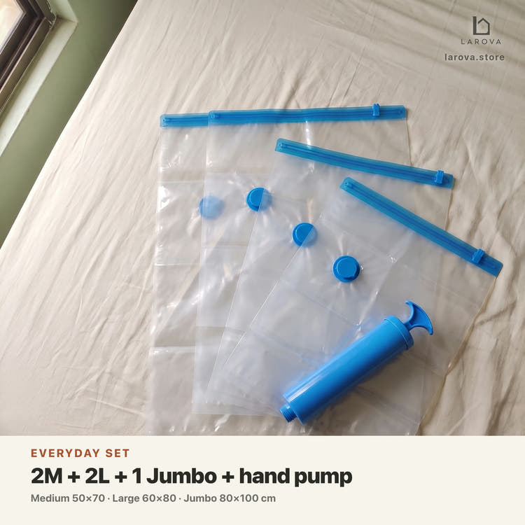 Everyday Set contents — 2 Medium, 2 Large and 1 Jumbo vacuum bag with the free hand pump, laid out on a bed