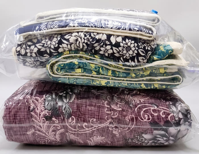 Double razai sealed flat in a Jumbo vacuum bag, with a second bag of folded quilts stacked on top